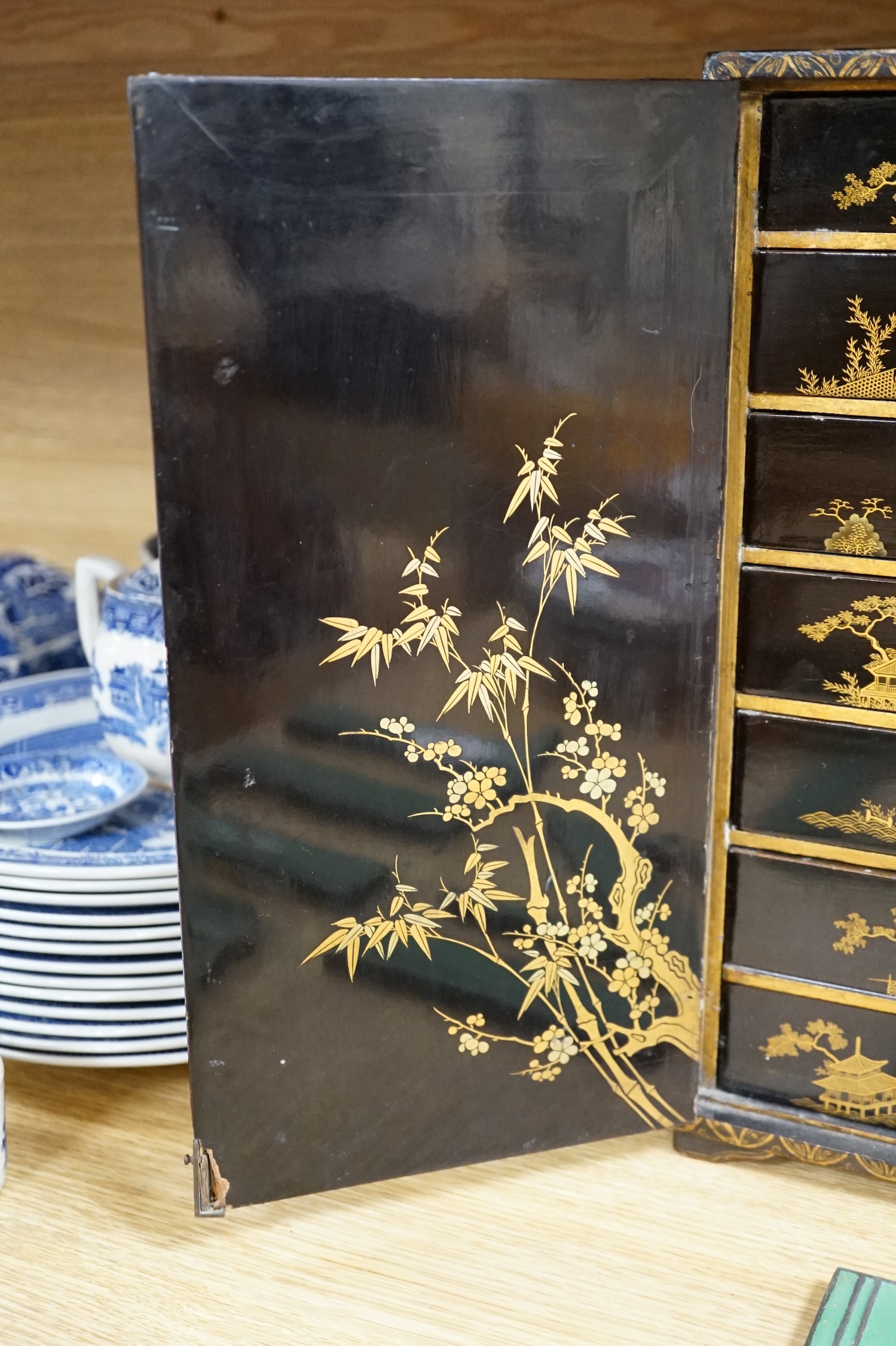 A 19th century Japanese gilt lacquered table cabinet, 38cm tall. Condition - fair